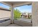 Relax on this balcony, featuring a metal railing, stucco walls, and views of the surrounding neighborhood at 10505 Howling Coyote Ave, Las Vegas, NV 89135