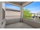 Relax on this balcony, featuring a metal railing, stucco walls, and views of the surrounding neighborhood at 10505 Howling Coyote Ave, Las Vegas, NV 89135