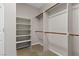 Organized walk-in closet with shelving and hanging rods for ample storage at 10505 Howling Coyote Ave, Las Vegas, NV 89135