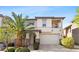 Inviting two-story home featuring a desert landscape and balcony at 10505 Howling Coyote Ave, Las Vegas, NV 89135