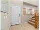 Welcoming foyer with tile flooring, staircase, and high ceilings at 10505 Howling Coyote Ave, Las Vegas, NV 89135