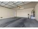 Spacious two-car garage with concrete floors and a high ceiling, perfect for storage or workshop space at 10505 Howling Coyote Ave, Las Vegas, NV 89135