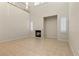 Bright living room with high ceilings, tile floors, and a cozy fireplace at 10505 Howling Coyote Ave, Las Vegas, NV 89135