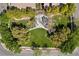 An aerial view captures a community park featuring lush greenery, mature trees, and winding walkways at 10505 Howling Coyote Ave, Las Vegas, NV 89135