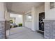 Welcoming front porch featuring stone accents and a stylish security door at 10505 Howling Coyote Ave, Las Vegas, NV 89135
