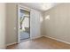 Bright room featuring tiled floors, a modern chandelier, and a sliding glass door to the backyard at 10505 Howling Coyote Ave, Las Vegas, NV 89135
