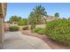 Manicured backyard with mature landscaping, stone pathway, and retaining walls at 10800 Brinkwood Ave, Las Vegas, NV 89134