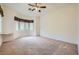 Bright bedroom features a ceiling fan, carpeted floors, and a large window with backyard views, creating a serene retreat at 10800 Brinkwood Ave, Las Vegas, NV 89134