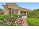 Charming single-story home with well-manicured front yard, lush landscaping, and inviting covered porch at 10800 Brinkwood Ave, Las Vegas, NV 89134