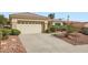 Inviting single-story home featuring a spacious two-car garage, neutral tones, and desert landscaping at 10800 Brinkwood Ave, Las Vegas, NV 89134