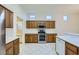 Updated kitchen with stainless steel appliances, wood cabinetry, and a view to the adjacent nook, creating a functional cooking space at 10800 Brinkwood Ave, Las Vegas, NV 89134