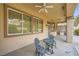 Relaxing covered patio with ceiling fans, charming table set, and built-in grill, perfect for entertaining at 10800 Brinkwood Ave, Las Vegas, NV 89134
