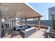 Covered patio with outdoor seating, fire pit, grill area, and desert landscaping at 1136 Jamesbury Rd, Las Vegas, NV 89135
