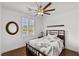 Cozy bedroom features hardwood floors, neutral decor, ceiling fan, and bright natural light at 1136 Jamesbury Rd, Las Vegas, NV 89135