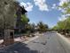 Gated community entrance with lush landscaping and a secure access point creating an inviting and secure residential environment at 1136 Jamesbury Rd, Las Vegas, NV 89135