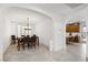 Bright dining room featuring a modern chandelier, plantation shutters, and neutral tile floors at 1136 Jamesbury Rd, Las Vegas, NV 89135