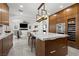 Modern kitchen featuring a central island with seating, integrated stainless steel appliances, and abundant storage at 1136 Jamesbury Rd, Las Vegas, NV 89135