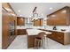 Modern kitchen with sleek wood cabinetry, stainless steel appliances, a large island, and stylish pendant lighting at 1136 Jamesbury Rd, Las Vegas, NV 89135