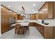 Modern kitchen with sleek wood cabinetry, stainless steel appliances, a large island, and stylish pendant lighting at 1136 Jamesbury Rd, Las Vegas, NV 89135