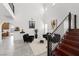 Bright living room features soaring ceilings, a modern staircase, neutral walls, and tile flooring that create an airy feel at 1136 Jamesbury Rd, Las Vegas, NV 89135