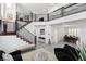 Bright living room features soaring ceilings, a modern staircase, neutral walls, and tile flooring that create an airy feel at 1136 Jamesbury Rd, Las Vegas, NV 89135