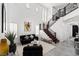 Bright living room features soaring ceilings, a modern staircase, neutral walls, and tile flooring that create an airy feel at 1136 Jamesbury Rd, Las Vegas, NV 89135