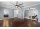 Spacious main bedroom with hardwood floors, a ceiling fan, and an archway to a bathroom at 1136 Jamesbury Rd, Las Vegas, NV 89135