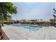 Community pool featuring lounge chairs, covered seating areas, and lush surrounding landscaping at 1136 Jamesbury Rd, Las Vegas, NV 89135