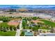 Vibrant aerial view of the baseball fields and playground, surrounded by lush greenery and city skyline at 1162 Red Margin Ct # 101, Las Vegas, NV 89183