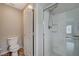 Clean bathroom featuring a toilet and a white tiled shower with glass door at 1162 Red Margin Ct # 101, Las Vegas, NV 89183