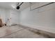 Spacious two-car garage with a side entry door and concrete flooring at 1162 Red Margin Ct # 101, Las Vegas, NV 89183