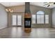 Spacious living room with fireplace, wood floors, vaulted ceilings, and French doors at 1162 Red Margin Ct # 101, Las Vegas, NV 89183