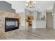 Open-concept living area featuring a fireplace and hardwood floors, leading into the kitchen at 1162 Red Margin Ct # 101, Las Vegas, NV 89183