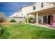 Grassy backyard including a patio, pergola covered seating area and mature landscaping for outdoor enjoyment at 1163 Regal Lily Way, Las Vegas, NV 89123
