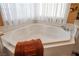 Serene bathroom showcasing a luxurious corner bathtub with tile surround at 1163 Regal Lily Way, Las Vegas, NV 89123