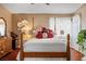 Comfortable bedroom featuring a classic four-poster bed and ample natural light at 1163 Regal Lily Way, Las Vegas, NV 89123