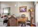 An elegant dining room with wood furniture, decor, and a large window creates an inviting space for meals at 1163 Regal Lily Way, Las Vegas, NV 89123