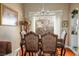 Formal dining area featuring an elegant chandelier, wood floors and large window with backyard views at 1163 Regal Lily Way, Las Vegas, NV 89123
