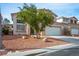 Inviting two-story home with a manicured front yard and a spacious two-car garage at 1163 Regal Lily Way, Las Vegas, NV 89123