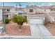 Two-story home with well-maintained yard, landscaping, and concrete driveway at 1163 Regal Lily Way, Las Vegas, NV 89123