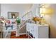 Bright foyer featuring hardwood floors, staircase, and decorative table with flowers and lamps at 1163 Regal Lily Way, Las Vegas, NV 89123
