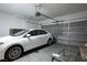 Well-lit garage with car parked inside, featuring gray door and ample storage space at 1163 Regal Lily Way, Las Vegas, NV 89123