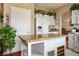 Bright kitchen featuring white cabinets, stainless steel appliances, granite countertops and an island at 1163 Regal Lily Way, Las Vegas, NV 89123
