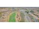 An aerial view features a golf course with a pond, offering scenic views and recreational opportunities at 1304 Autumn Wind Way, Henderson, NV 89052
