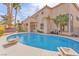 Backyard pool and patio area featuring a nearby hot tub, landscaping, and an outdoor dining area at 1304 Autumn Wind Way, Henderson, NV 89052