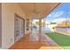 Covered patio overlooking a backyard oasis with pool, hot tub, and manicured landscaping at 1304 Autumn Wind Way, Henderson, NV 89052