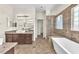 Bathroom with double vanity, standalone tub and tiled walk-in shower at 1304 Autumn Wind Way, Henderson, NV 89052