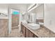 Updated bathroom featuring double vanity, granite countertop, and walk-in shower at 1304 Autumn Wind Way, Henderson, NV 89052