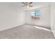 Spacious carpeted bedroom with a ceiling fan and a large window for natural light at 1304 Autumn Wind Way, Henderson, NV 89052