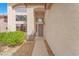 Home entrance with stucco walls, arched entryway, and desert landscaping at 1304 Autumn Wind Way, Henderson, NV 89052